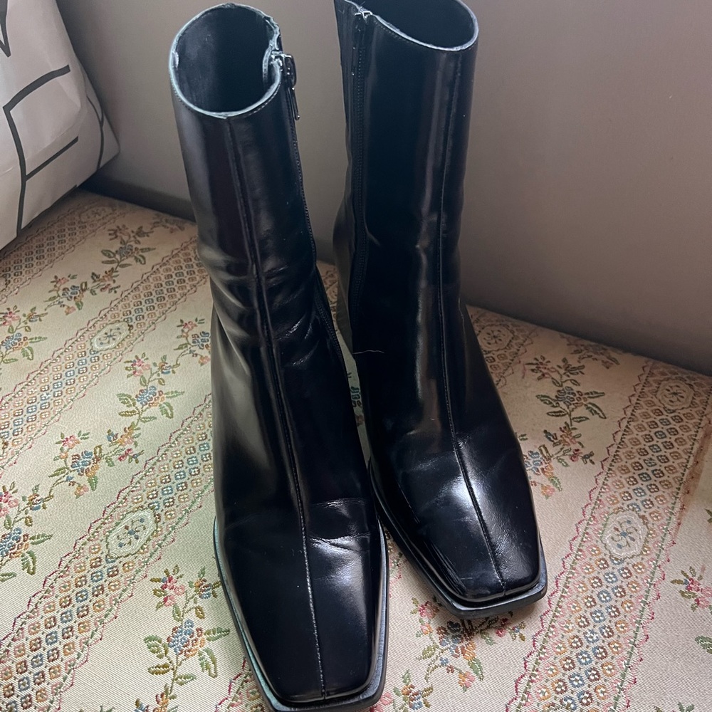 Black leather boots. 9 inches from top of boot to floor. 3-inch heel. Side zip.